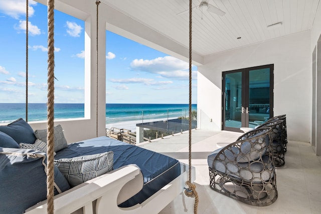 bedroom with a view of the beach and a water view