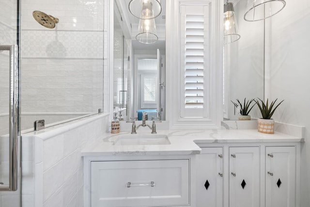 bathroom with an enclosed shower and vanity