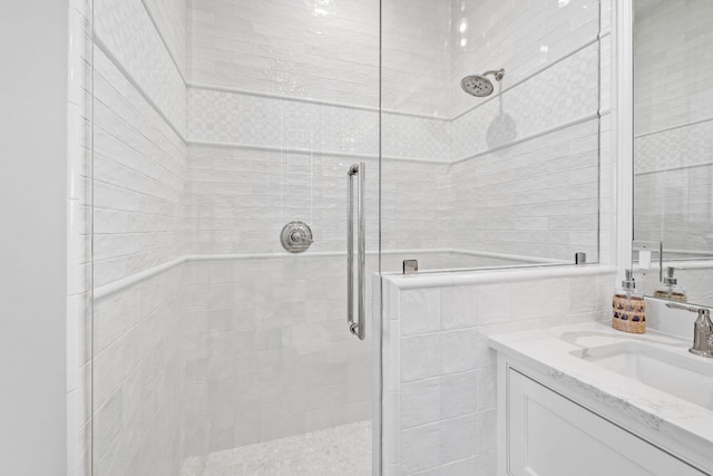 bathroom with walk in shower and vanity