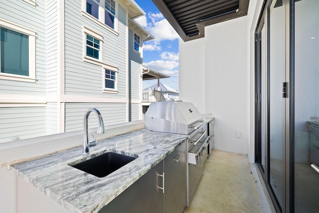 exterior space featuring exterior kitchen and sink