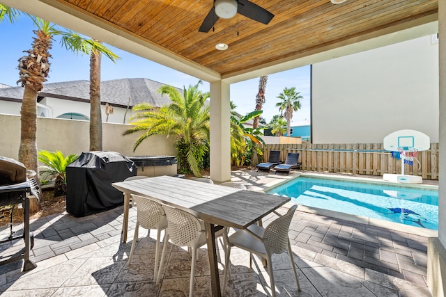 exterior space featuring ceiling fan, area for grilling, and a fenced in pool