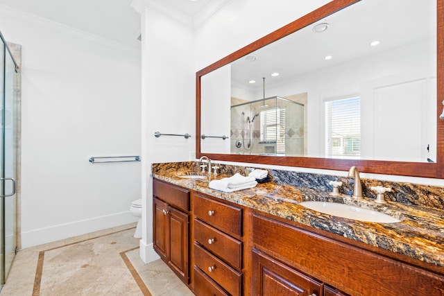 bathroom featuring dual bowl vanity, crown molding, a shower with door, tile flooring, and toilet