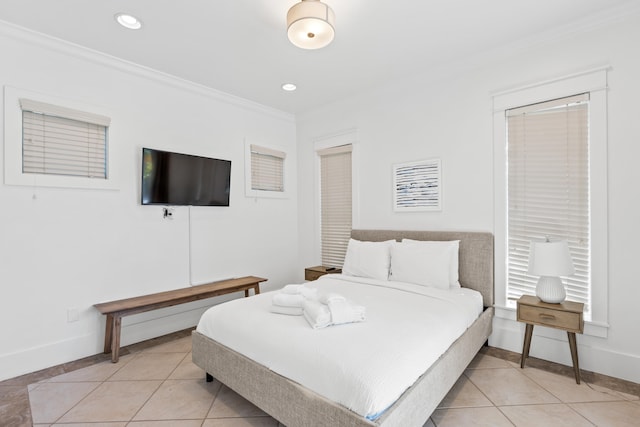 bedroom featuring ornamental molding and light tile floors