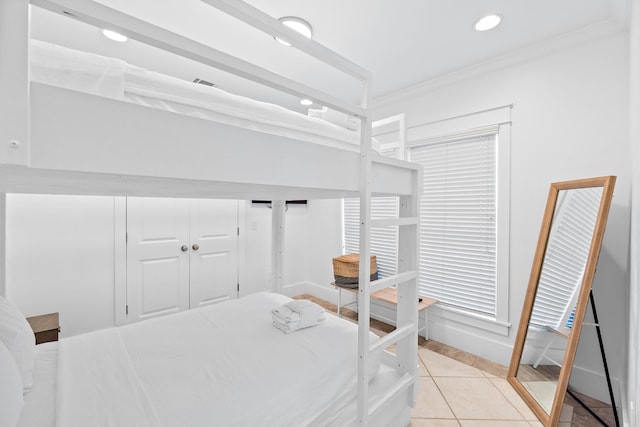 tiled bedroom featuring ornamental molding