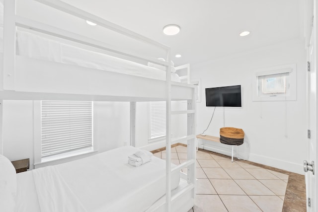 tiled bedroom featuring crown molding