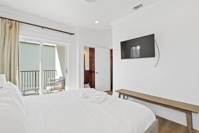 bedroom featuring ornamental molding, dark hardwood / wood-style flooring, and access to exterior