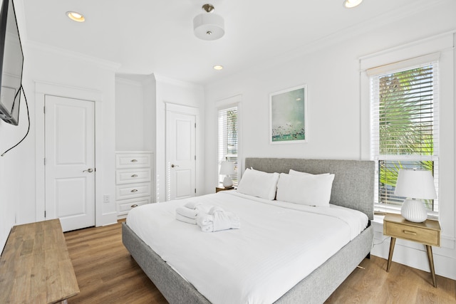 bedroom featuring ornamental molding and wood-type flooring