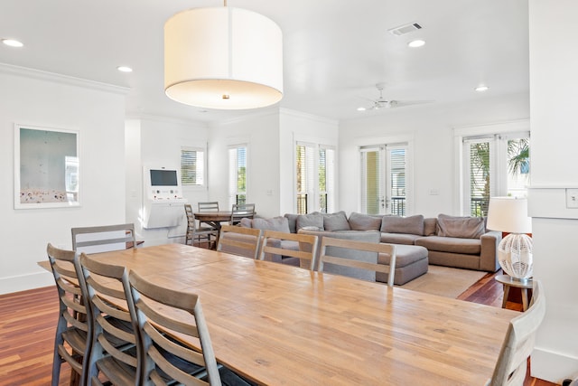 dining area with ornamental molding, light hardwood / wood-style floors, and ceiling fan