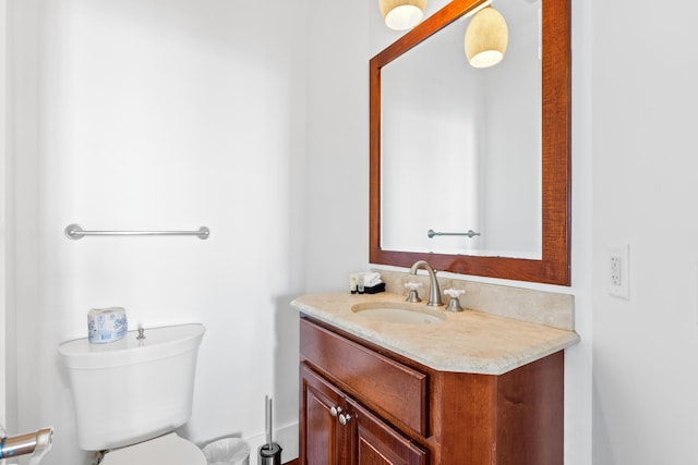 bathroom with vanity with extensive cabinet space and toilet