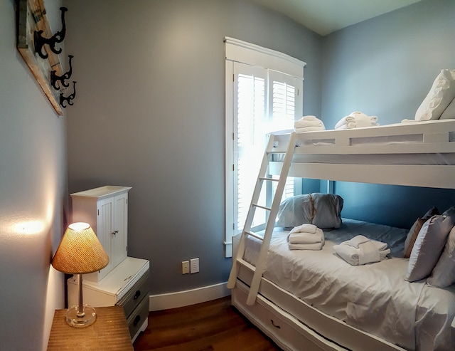 bedroom with dark wood-type flooring