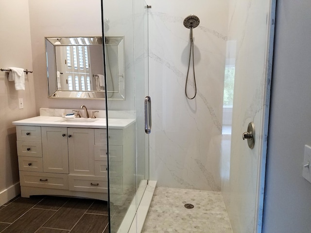 bathroom with vanity and a shower with shower door