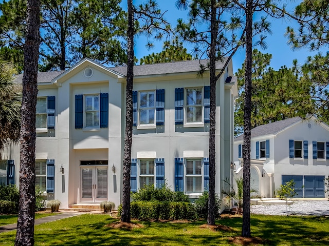 view of front of home featuring a front lawn and french doors