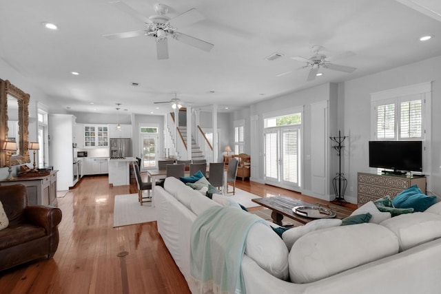 living room with light wood-type flooring and a healthy amount of sunlight