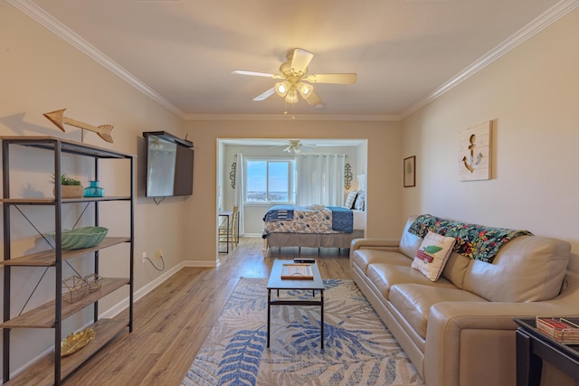 living room with wood-type flooring, ceiling fan, and crown molding