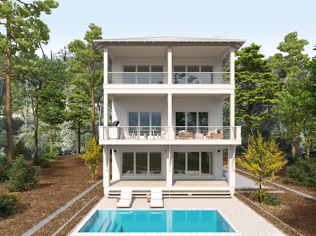 rear view of property featuring a balcony and a patio area