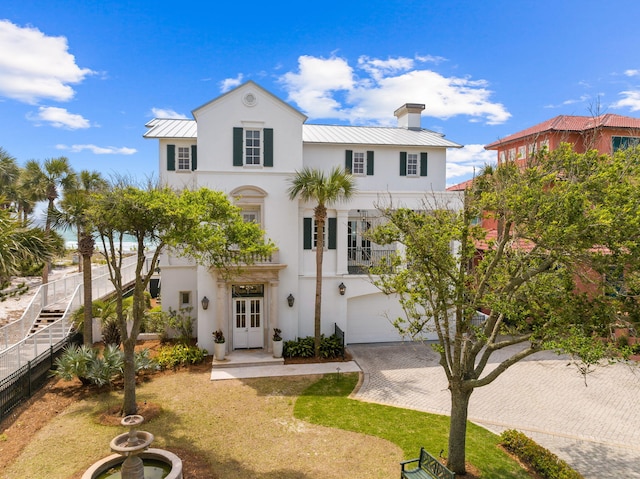 view of front of property with a front yard and a garage