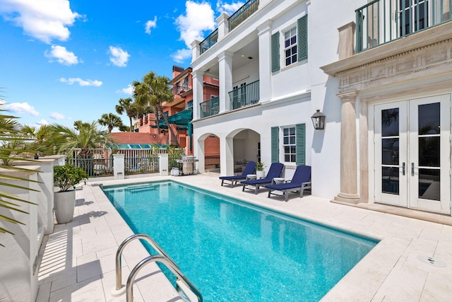 view of pool featuring a fenced in pool, a patio, area for grilling, fence, and french doors