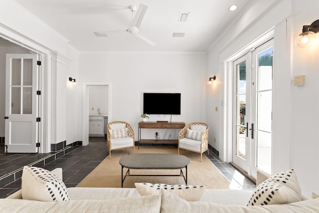 living area featuring baseboards, french doors, a ceiling fan, and crown molding