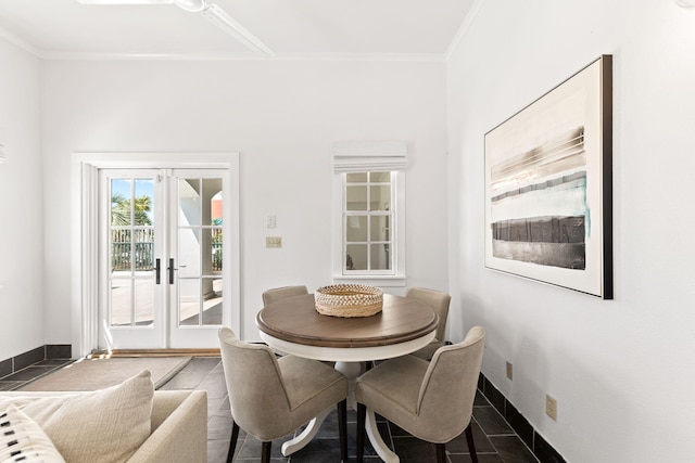 tiled dining area featuring french doors and crown molding