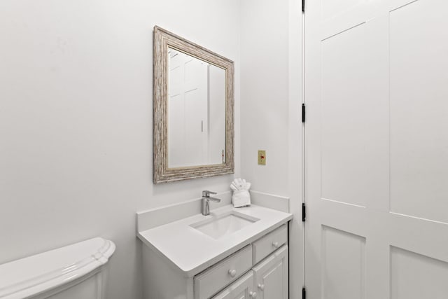 bathroom with toilet and large vanity