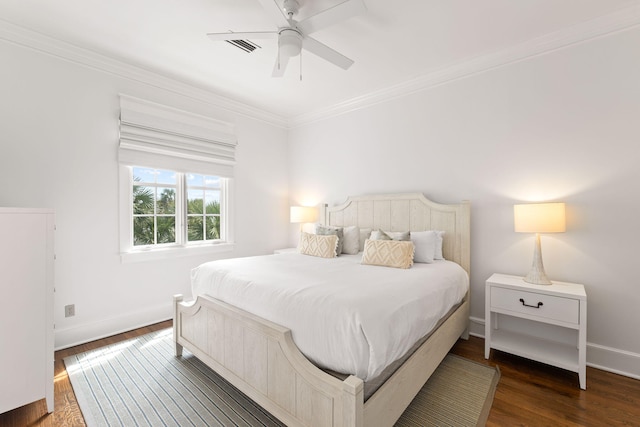 bedroom with a ceiling fan, dark wood-style flooring, crown molding, and baseboards