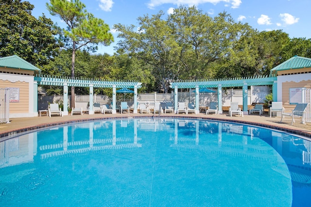 community pool with fence and a pergola