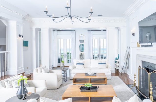 living area featuring a premium fireplace, ornamental molding, wood finished floors, and french doors