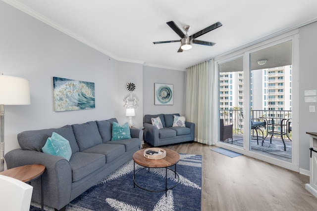 living room featuring ornamental molding, hardwood / wood-style floors, and ceiling fan