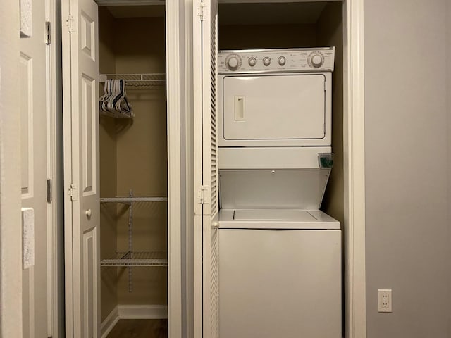 clothes washing area featuring stacked washer / dryer