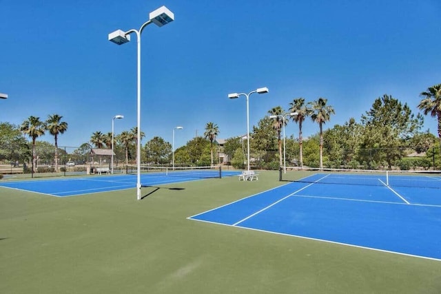 view of tennis court with fence