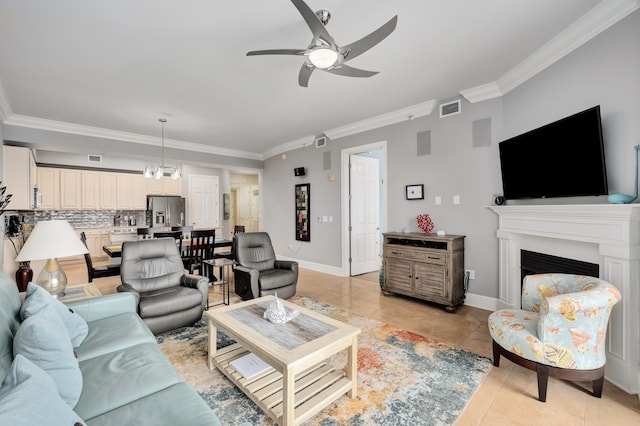 living room with ceiling fan, light tile flooring, and ornamental molding