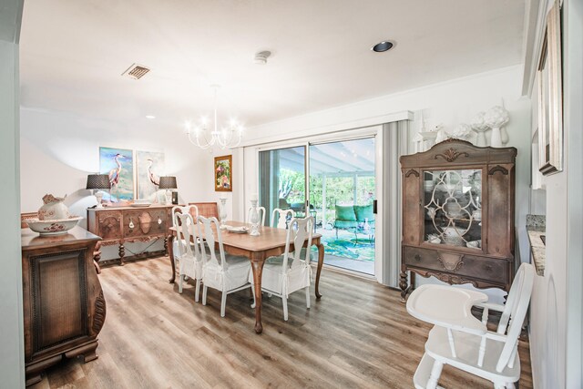 dining room featuring a notable chandelier and light hardwood / wood-style floors