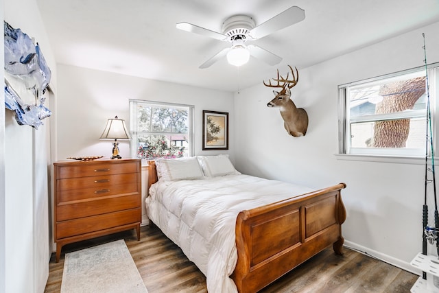 bedroom with ceiling fan and dark wood-type flooring