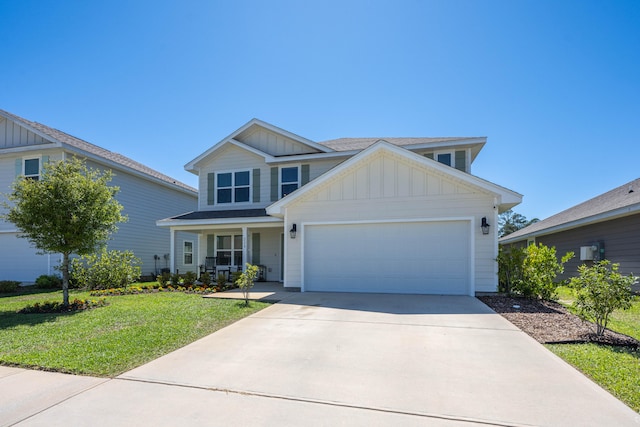 view of front of home with a garage, a front lawn, and covered porch