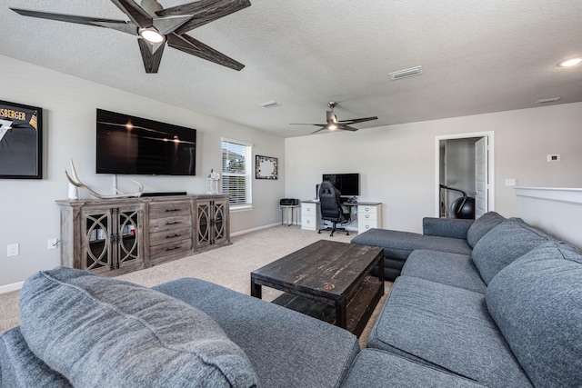 living room with a textured ceiling, carpet, and ceiling fan