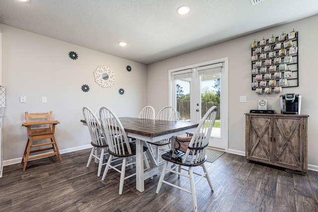 dining space with a textured ceiling, french doors, and dark hardwood / wood-style flooring