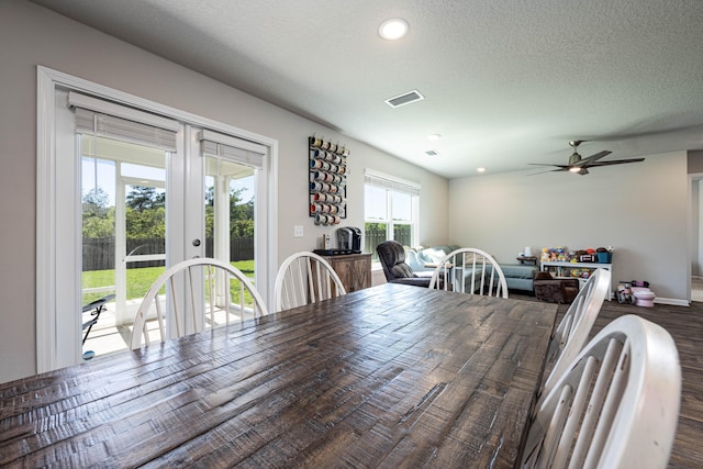 dining room featuring a textured ceiling, wood-type flooring, ceiling fan, and french doors