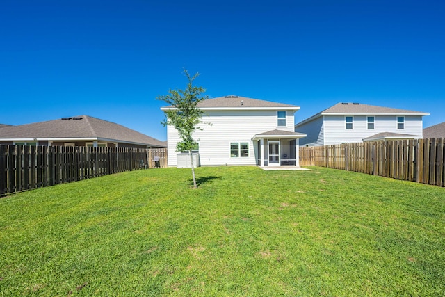 rear view of property featuring a lawn and a sunroom