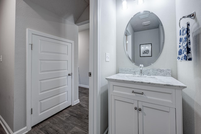 bathroom with vanity and hardwood / wood-style floors