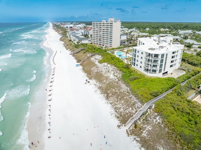 birds eye view of property featuring a water view and a beach view