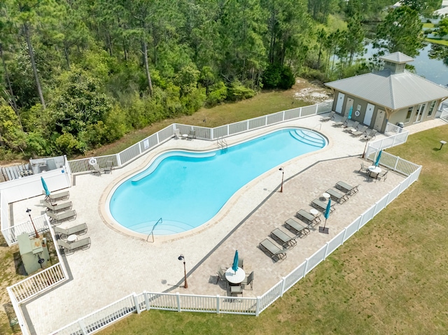 view of pool featuring a lawn and a patio