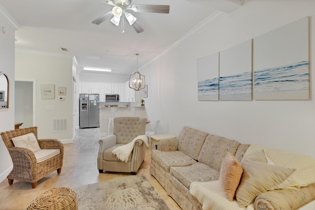 tiled living room with ceiling fan with notable chandelier and crown molding