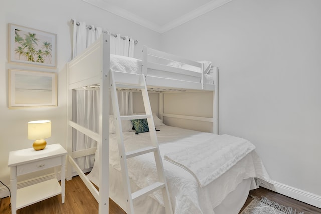 bedroom featuring hardwood / wood-style flooring and ornamental molding