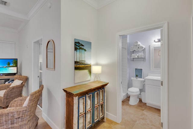 interior space with ornamental molding, vanity, toilet, and tile flooring