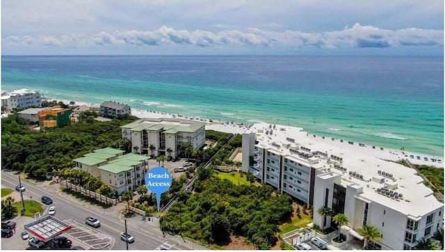 birds eye view of property featuring a view of the beach and a water view