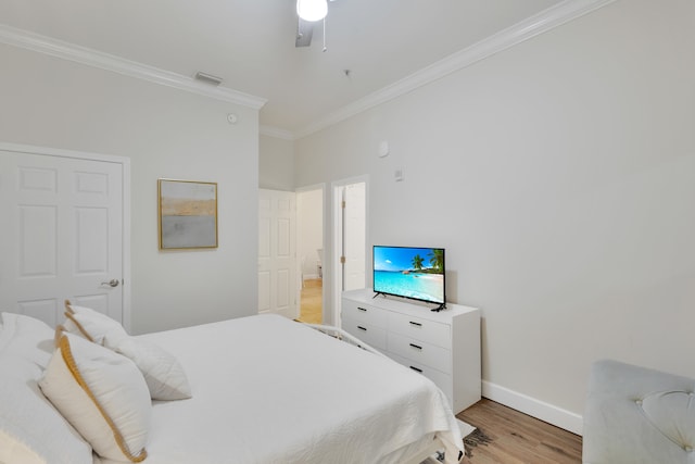 bedroom with ornamental molding, ceiling fan, and light wood-type flooring