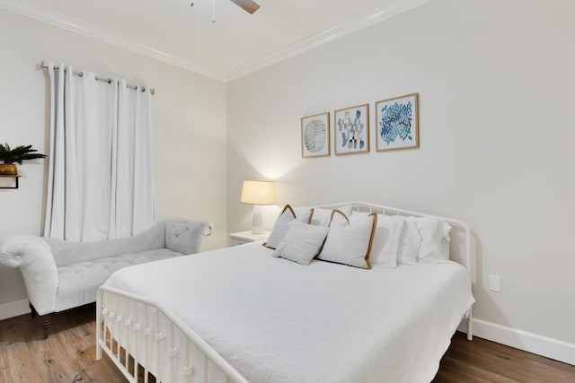 bedroom with dark hardwood / wood-style flooring, ceiling fan, and crown molding