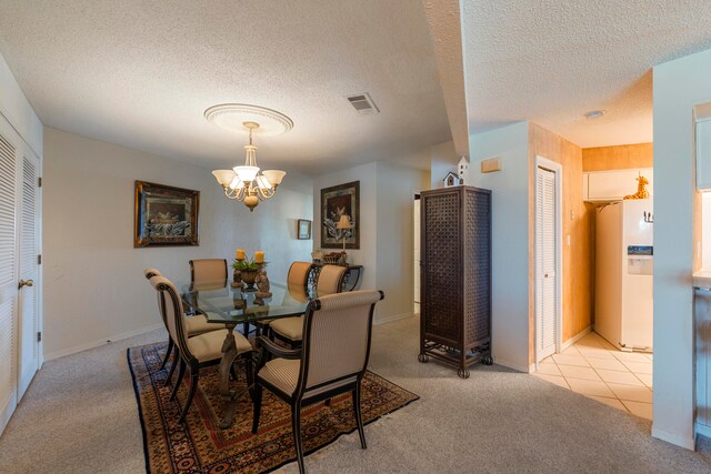 carpeted dining space featuring an inviting chandelier and a textured ceiling