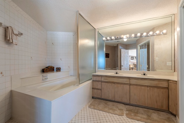 bathroom with tile flooring, tile walls, a textured ceiling, double vanity, and shower / bath combination with glass door