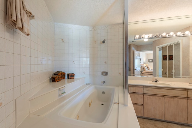 bathroom with vanity, tiled shower / bath combo, and a textured ceiling